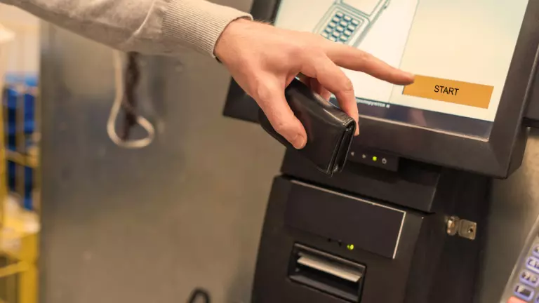 Customer using a self-service checkout